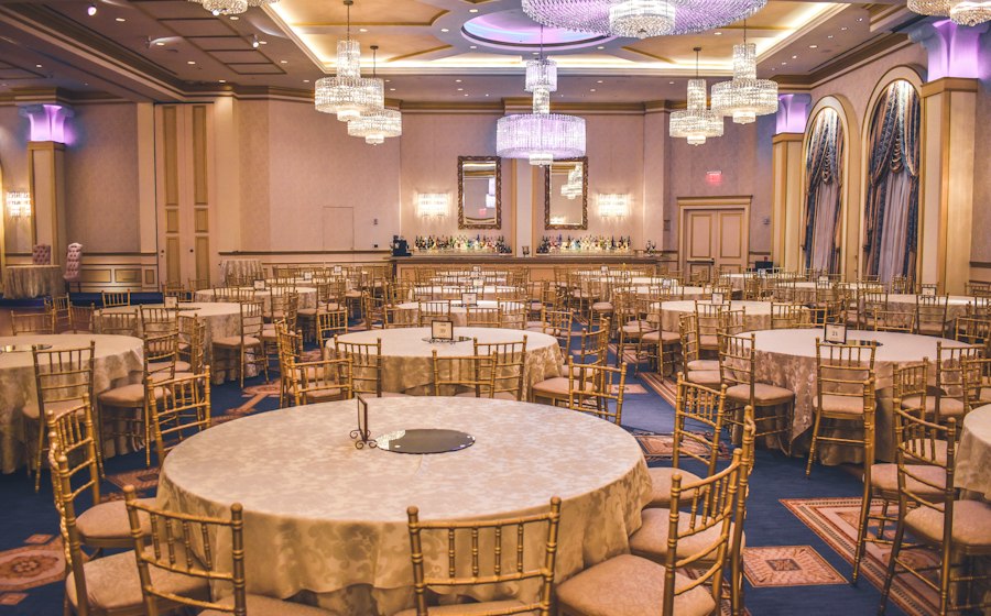 Keys Lite — hotel banquet hall set with round tables and chandeliers