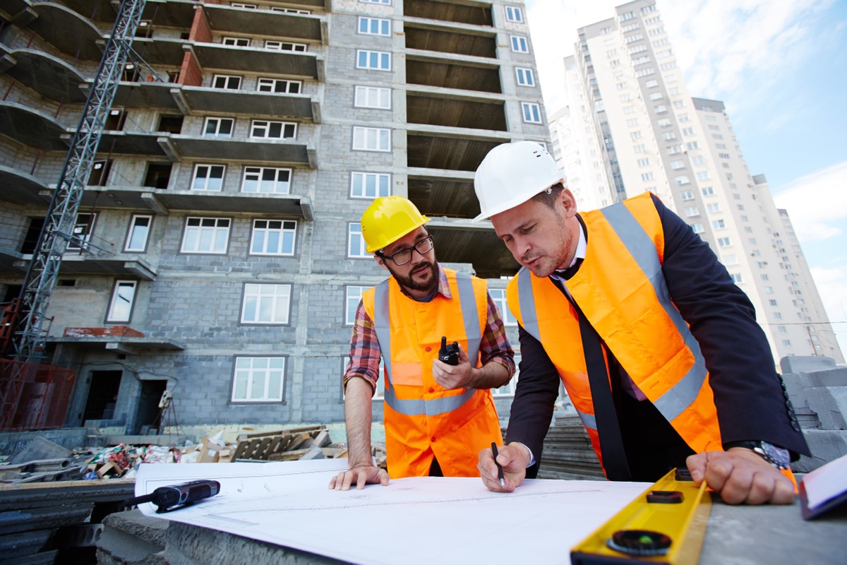 Builders reviewing plans at a construction site